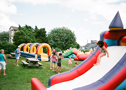 Children playing in our Slip & Slide, Dragon Maze and Castle Slide